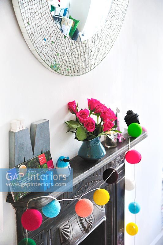 Colourful accessories on mantlepiece