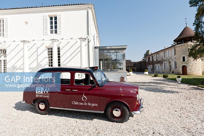 Taxi parked outside eighteenth century chateau
