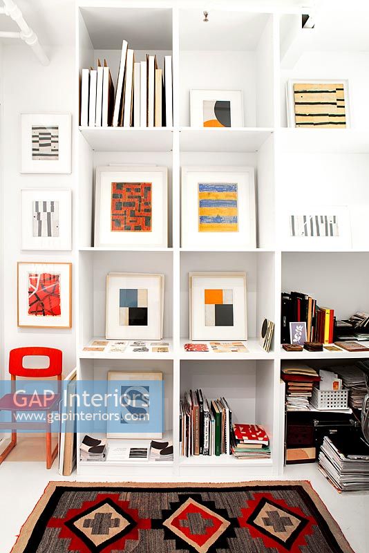 Abstract paintings by Robert Kelly displayed on shelves