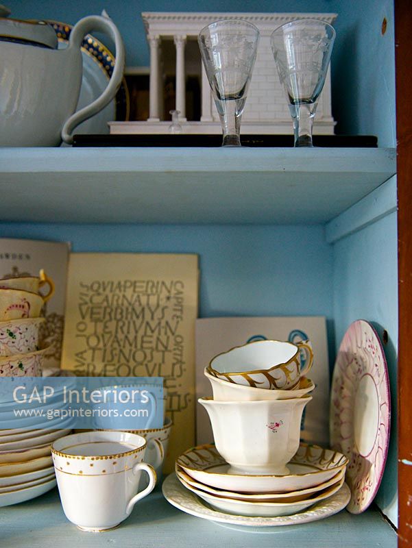 Patterned tableware on kitchen shelves