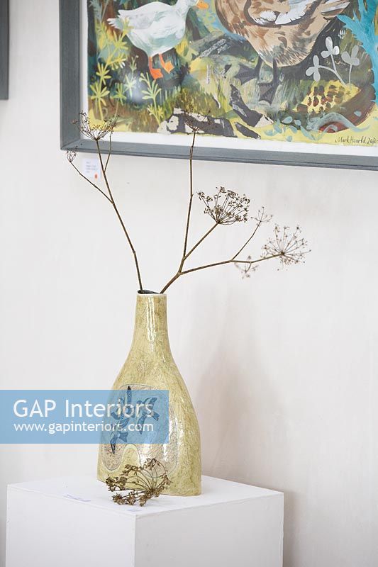 Dried flower heads in patterned vase