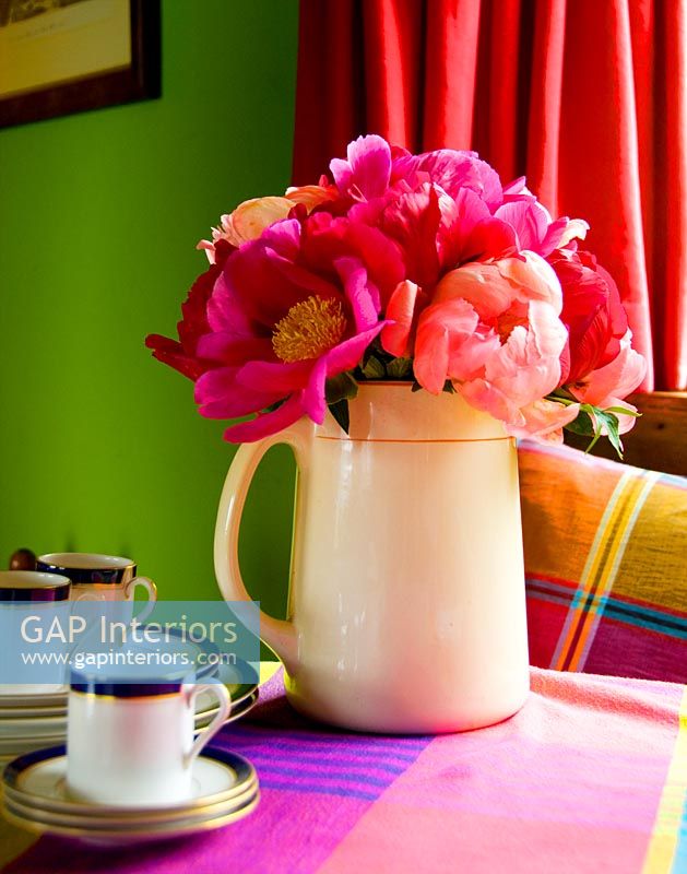 Colourful flowers in cream jug