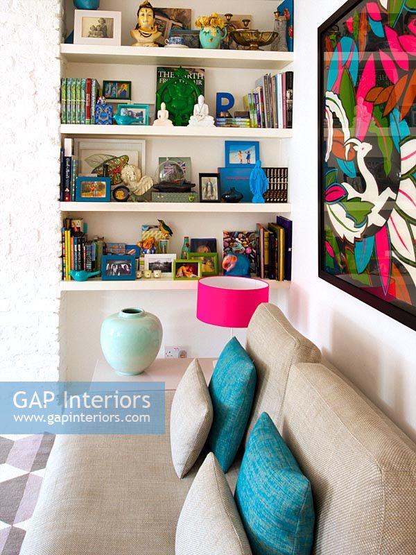 Colourful display of accessories on living room shelves