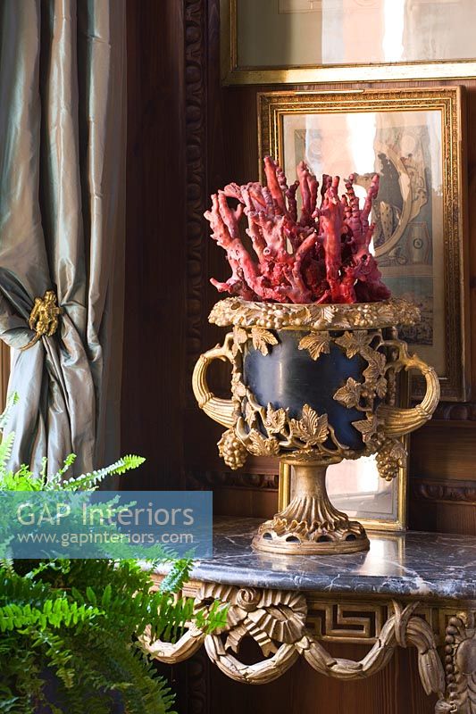 Ornate urn on marble console table