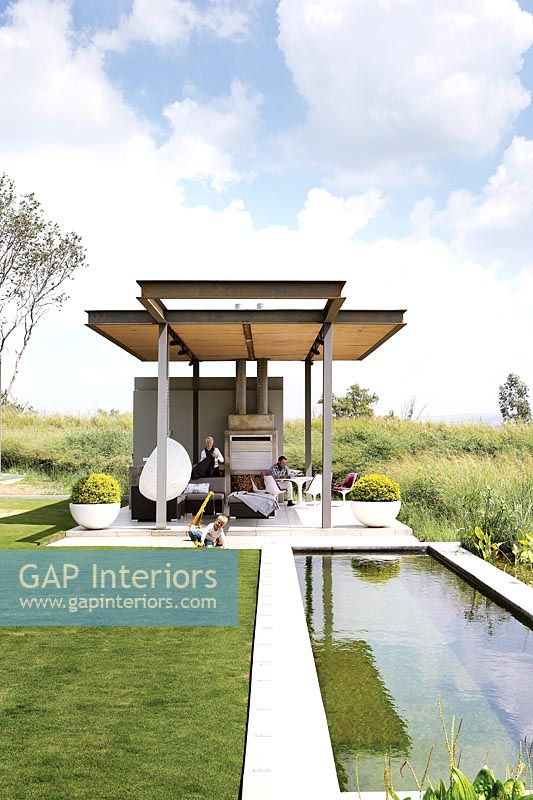 Contemporary garden with covered patio area