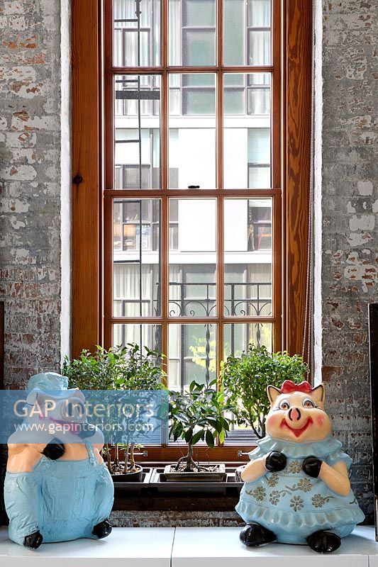 Toys and bonsai on windowsill