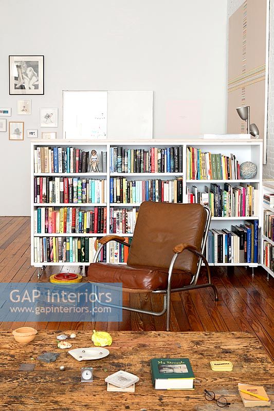 White bookcase in open plan apartment