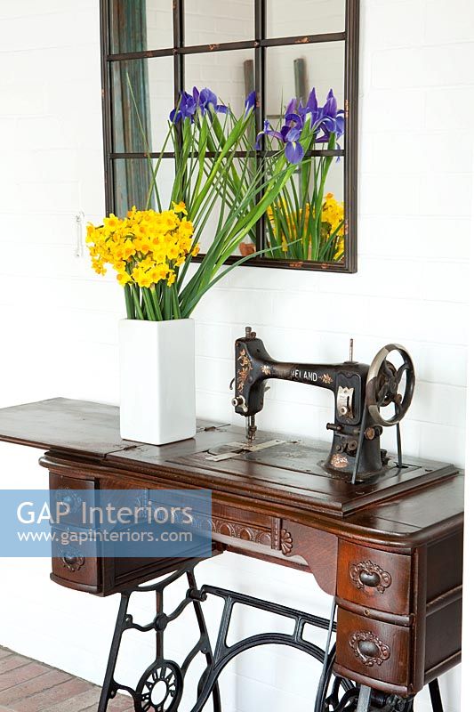 Daffodils and Irises in vase on vintage sewing machine