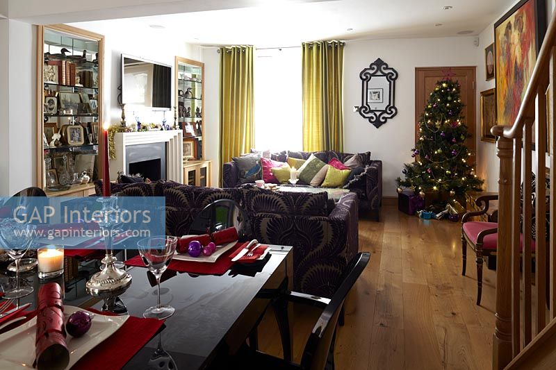 Modern open plan living and dining rooms decorated for christmas