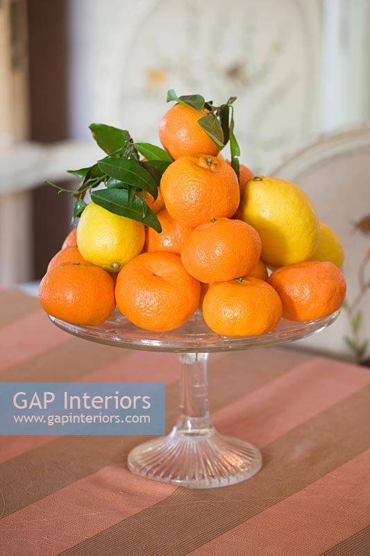 Glass cake stand with citrus fruits