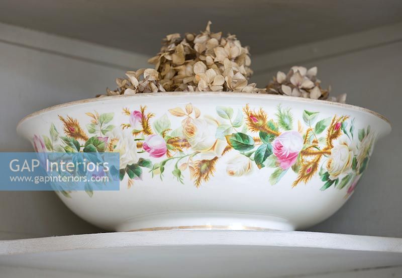 Vintage ceramic washbowl with dried Hydrangea flowers
