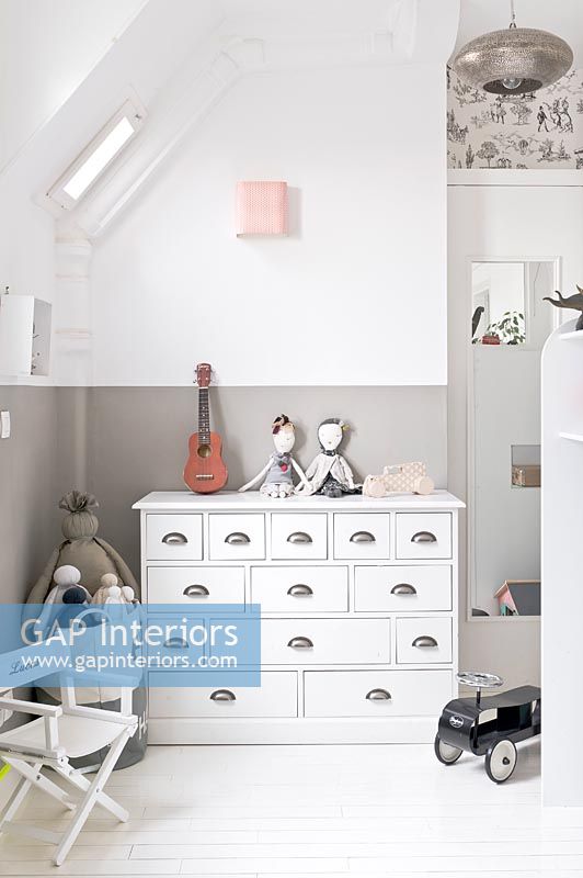 White chests of drawers in childs bedroom