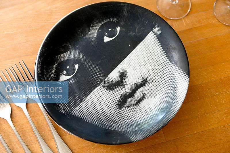 Fornasetti plate on wooden table
