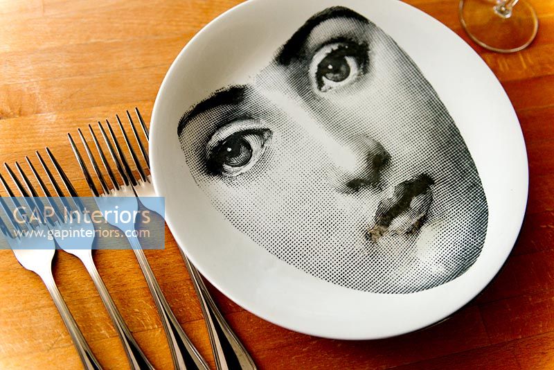 Fornasetti plate on wooden table
