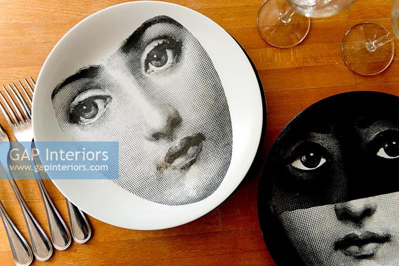 Fornasetti plates on wooden table