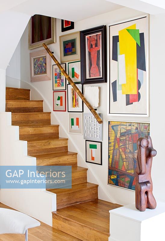Modern wooden staircase with art display