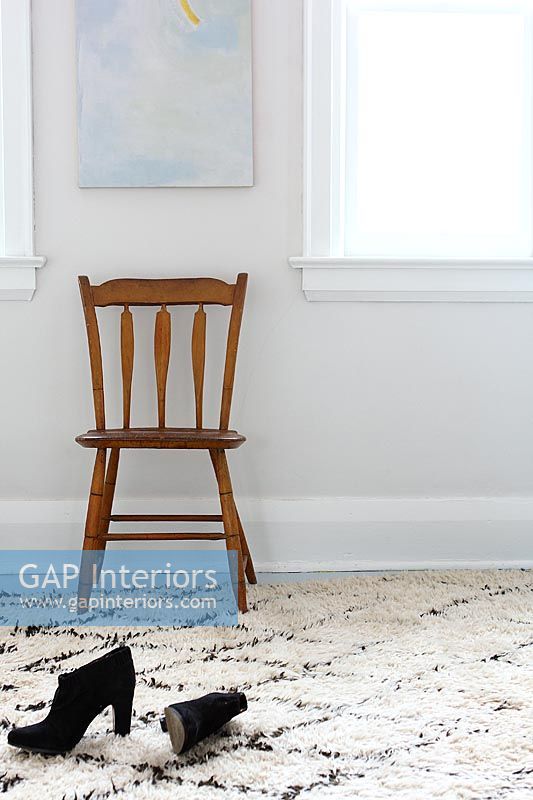 Wooden chair on patterned rug