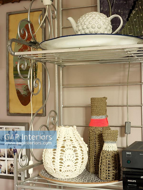 Crochet covered accessories on metal shelves