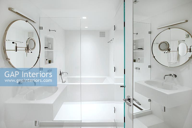 Mirrored door into white bathroom