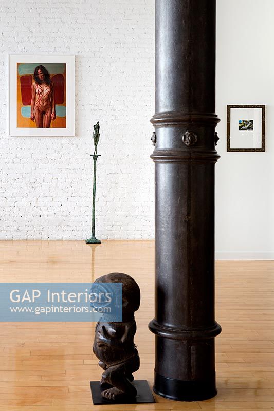 Tribal sculpture by classic column