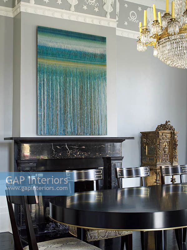 Modern painting hung above classic fireplace