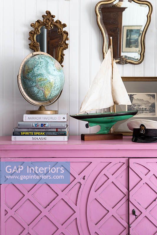 Accessories on pink sideboard