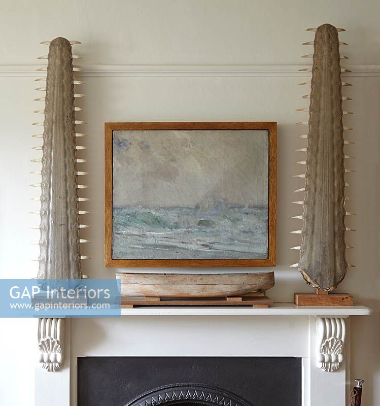 Nautical painting and ornaments on mantlepiece