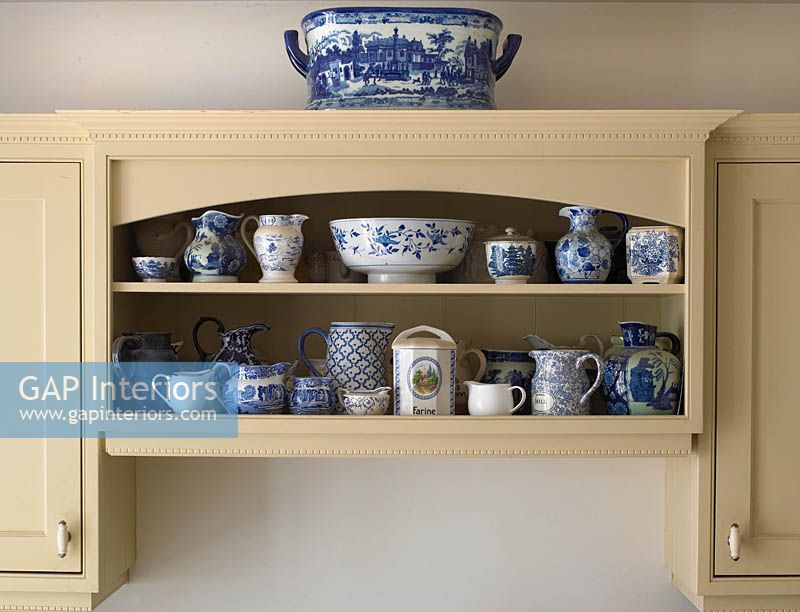 Display of patterned crockery on kitchen shelves