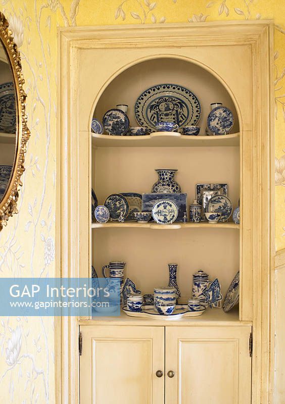 Patterned ceramics displayed in cabinet
