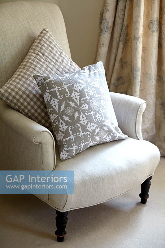 Patterned cushions on classic armchair