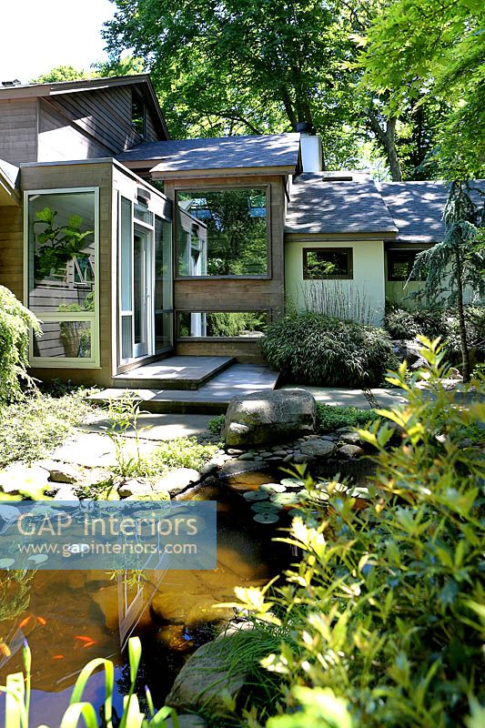 Modern house and garden with pond