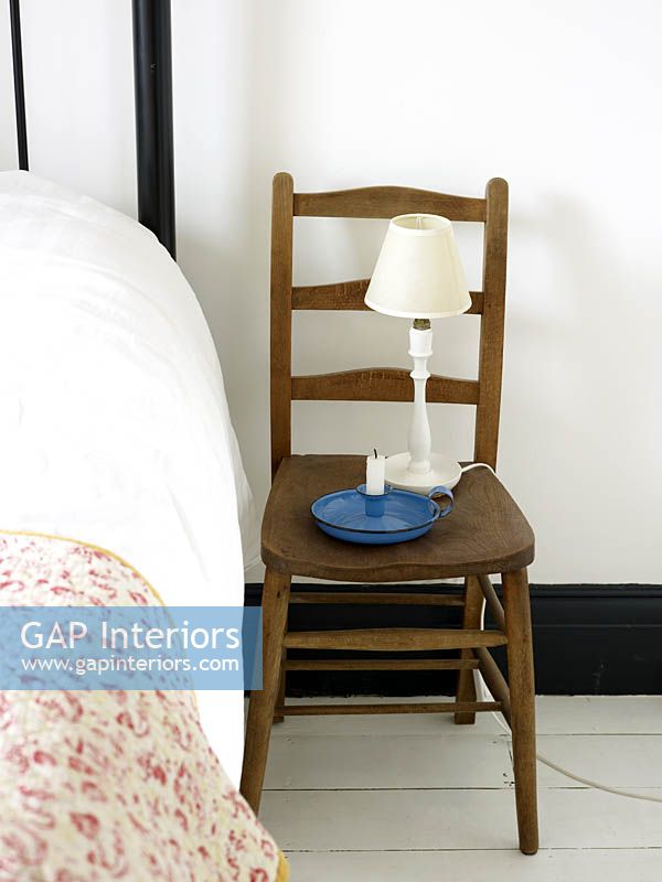 Wooden chair used as bedside table