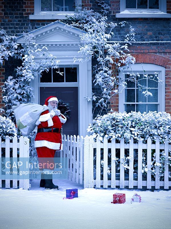 Santa outside a house