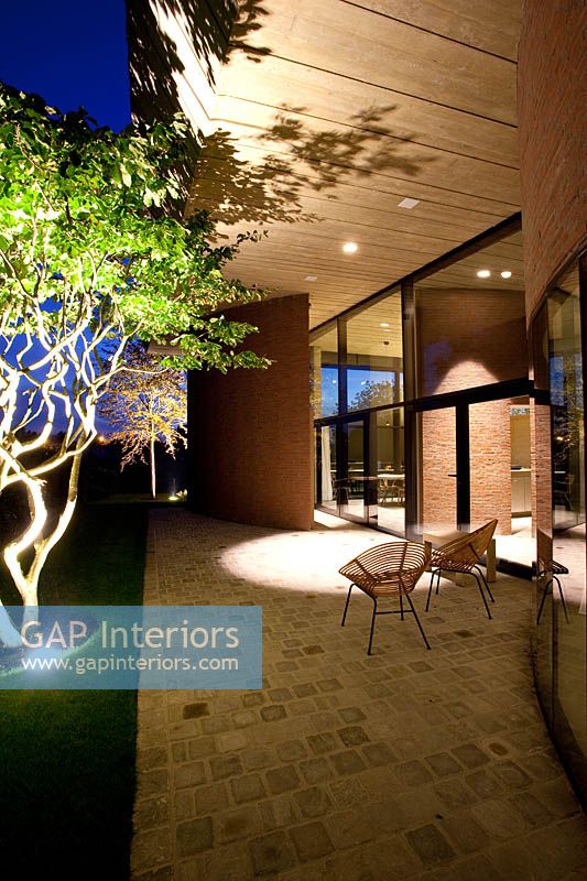 Contemporary house and patio lit up at night