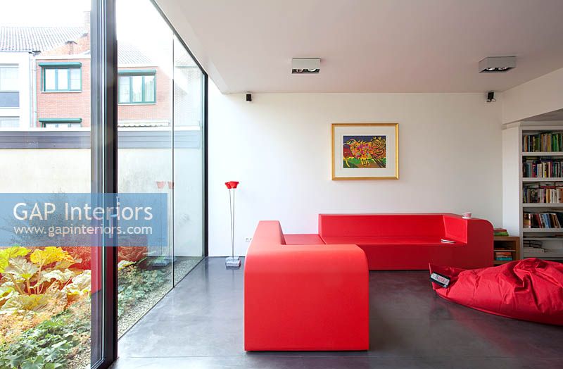Red sofas and floor cushion