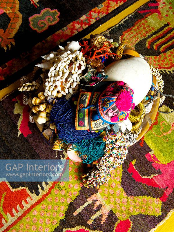 Tribal artefacts on patterned rug