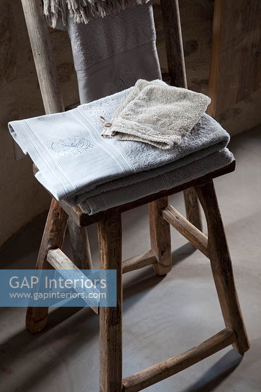 Towels on rustic wooden chair