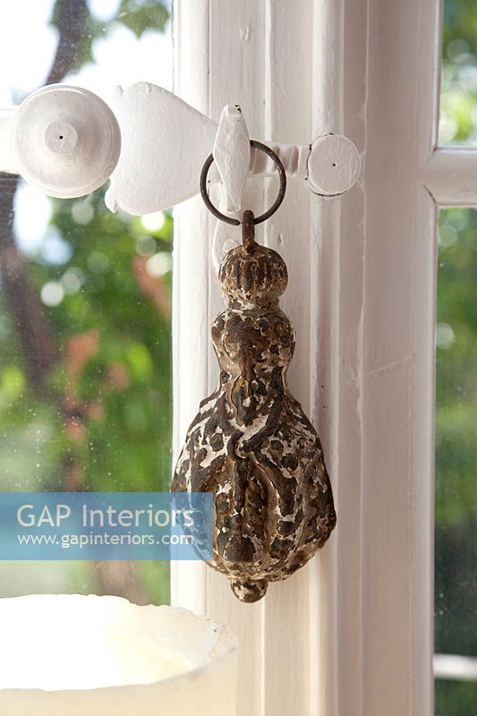 Vintage ornament hanging from window latch