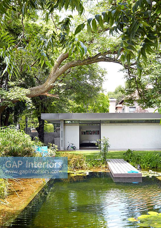 Modernist house and garden with pond