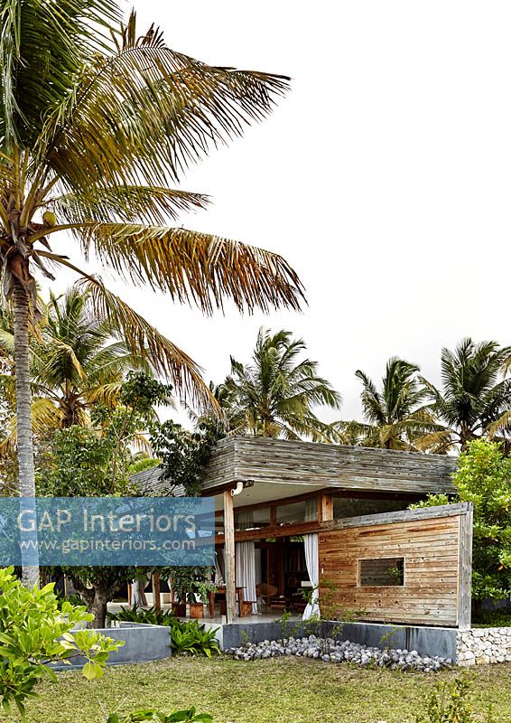Contemporary wooden house and tropical garden