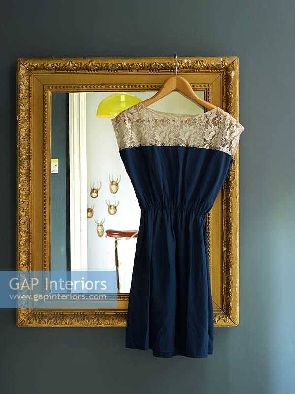 Dress hanging from vintage mirror
