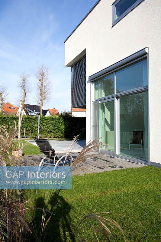 Contemporary house and garden with ornamental grasses