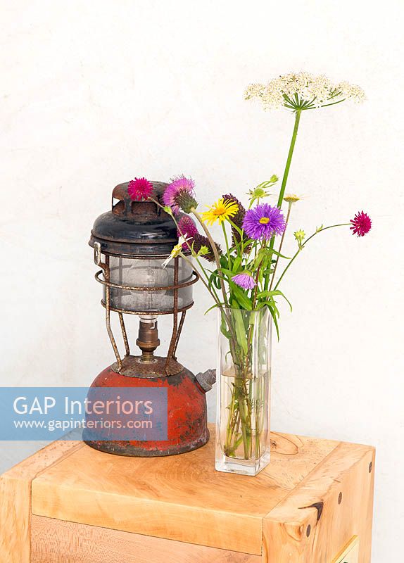 Vase of wildflowers and vintage lantern
