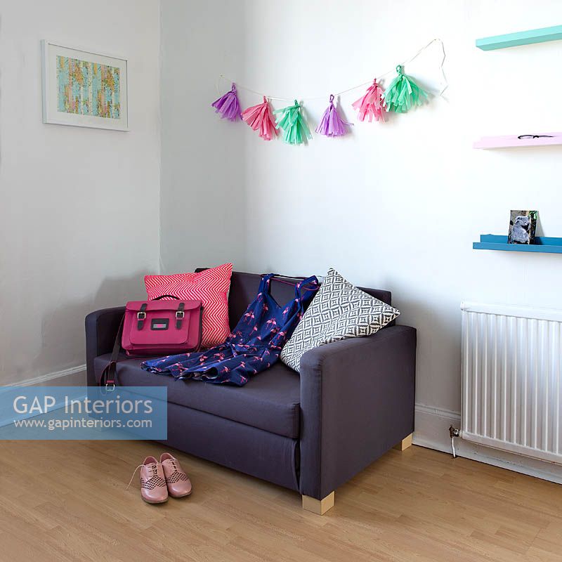 Colourful accessories on compact sofa
