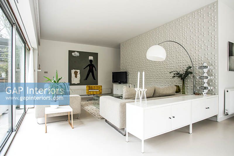 White living room with resin flooring