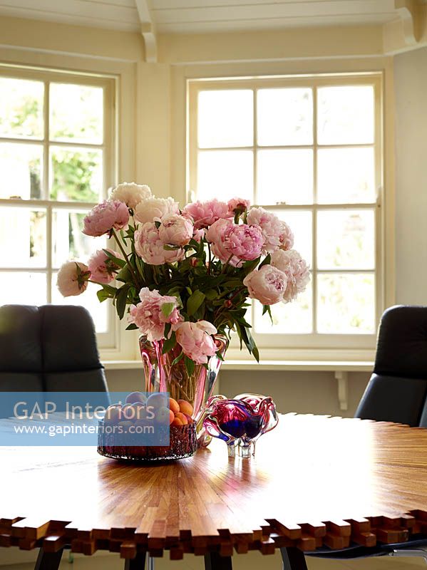 Vase of Peony flowers on dining table