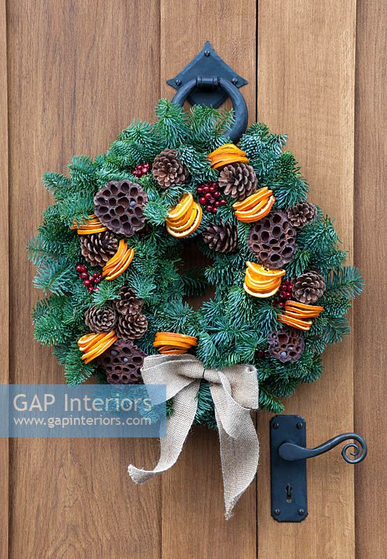 Christmas wreath of conifer foliage, pine cones and orange slices