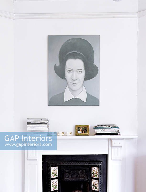 Portrait painting above fireplace