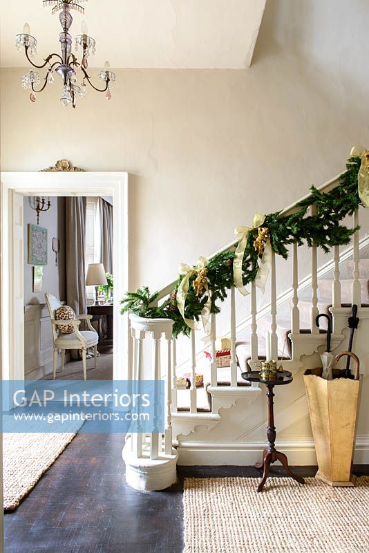 Christmas garland wrapped around bannisters