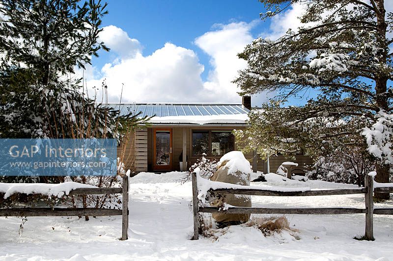 Wooden ranch style house in the snow